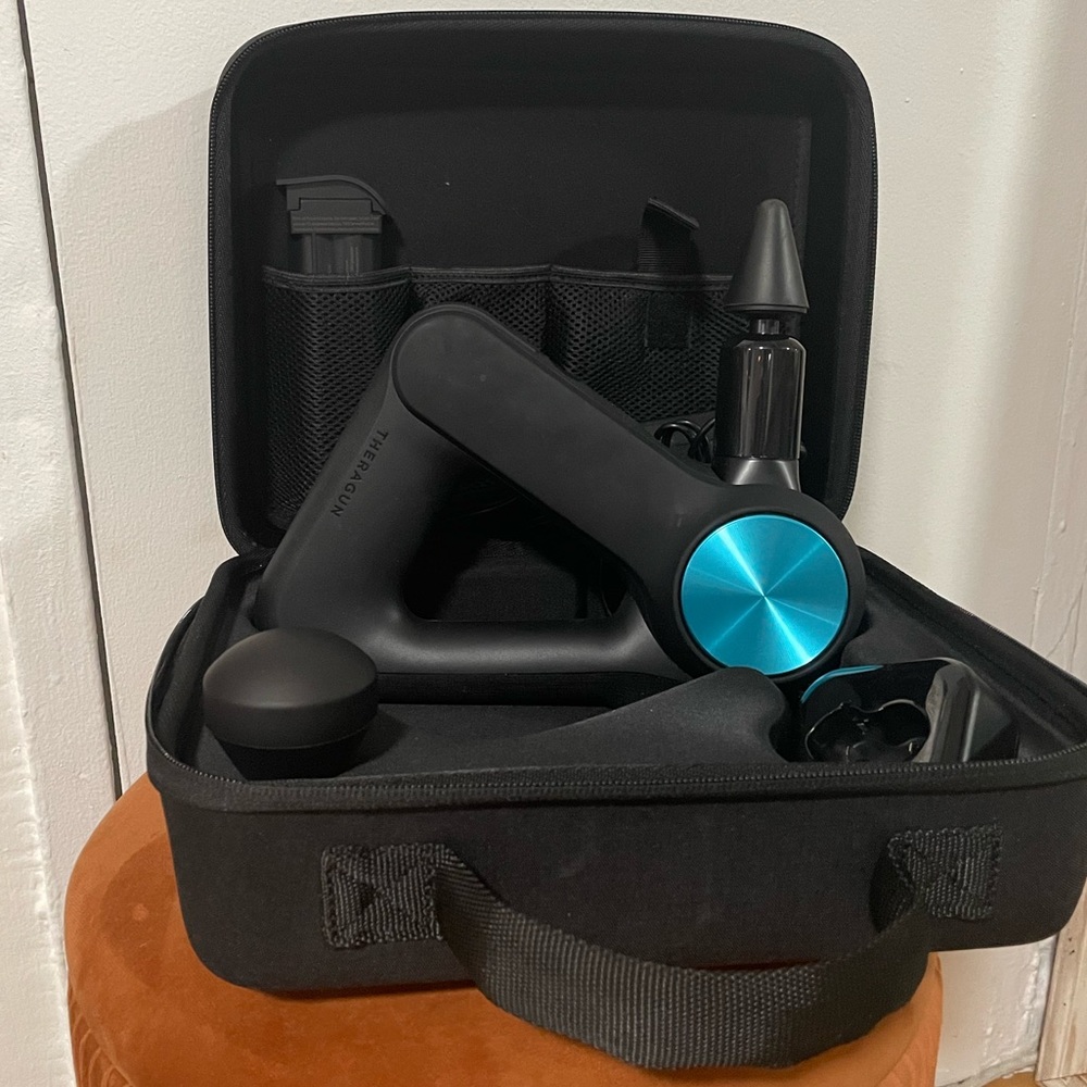 Theragun PRO with accessories, extra battery, charger, and carrying case